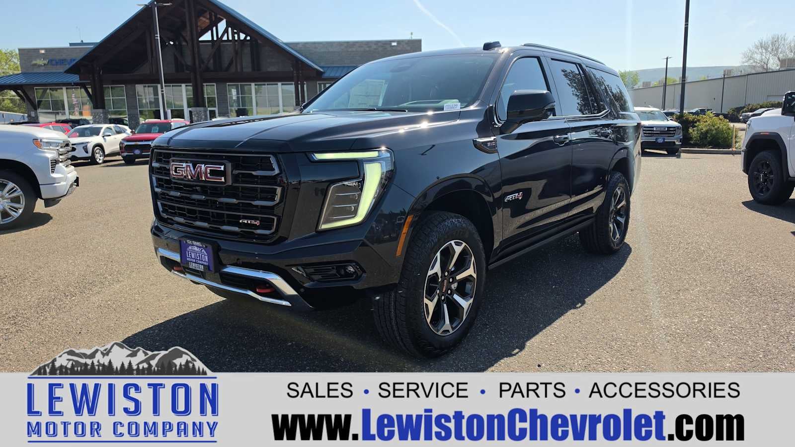 2026 GMC Yukon AT4 Ultimate in Titanium Rush Metallic — front three-quarter view